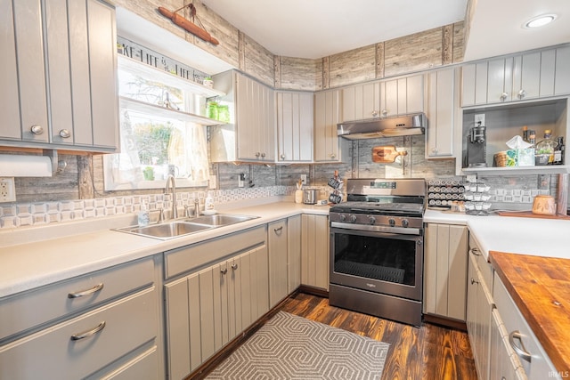 kitchen featuring sink, stainless steel gas range, wooden counters, dark hardwood / wood-style flooring, and gray cabinetry