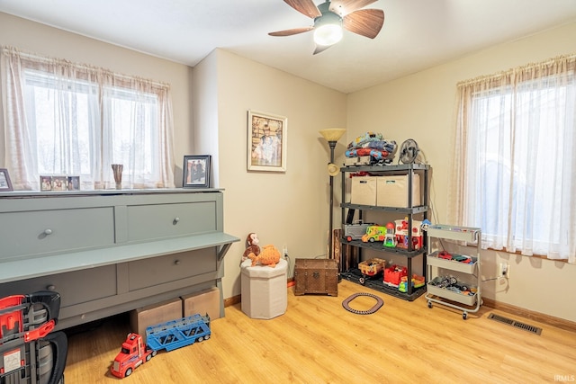 game room with ceiling fan and wood-type flooring