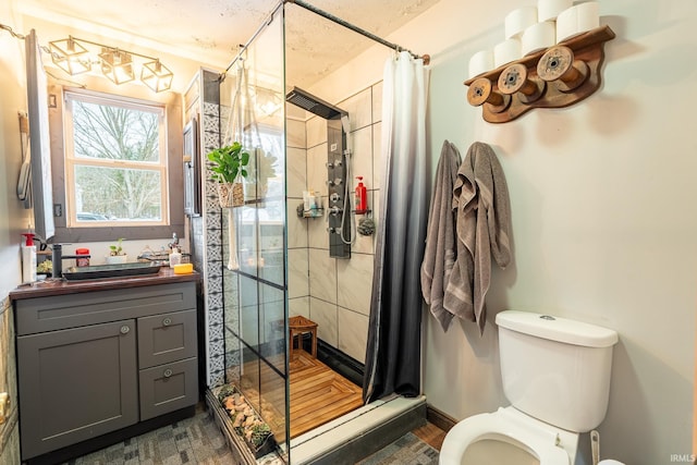 bathroom featuring toilet, a shower with shower curtain, vanity, and baseboard heating