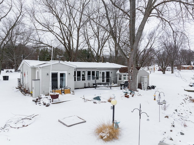 view of snow covered rear of property