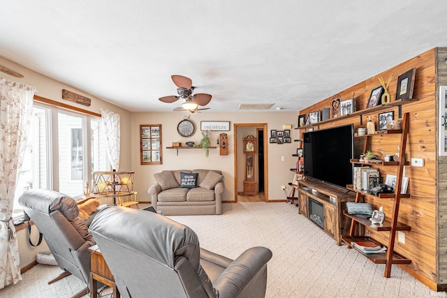 carpeted living room with ceiling fan