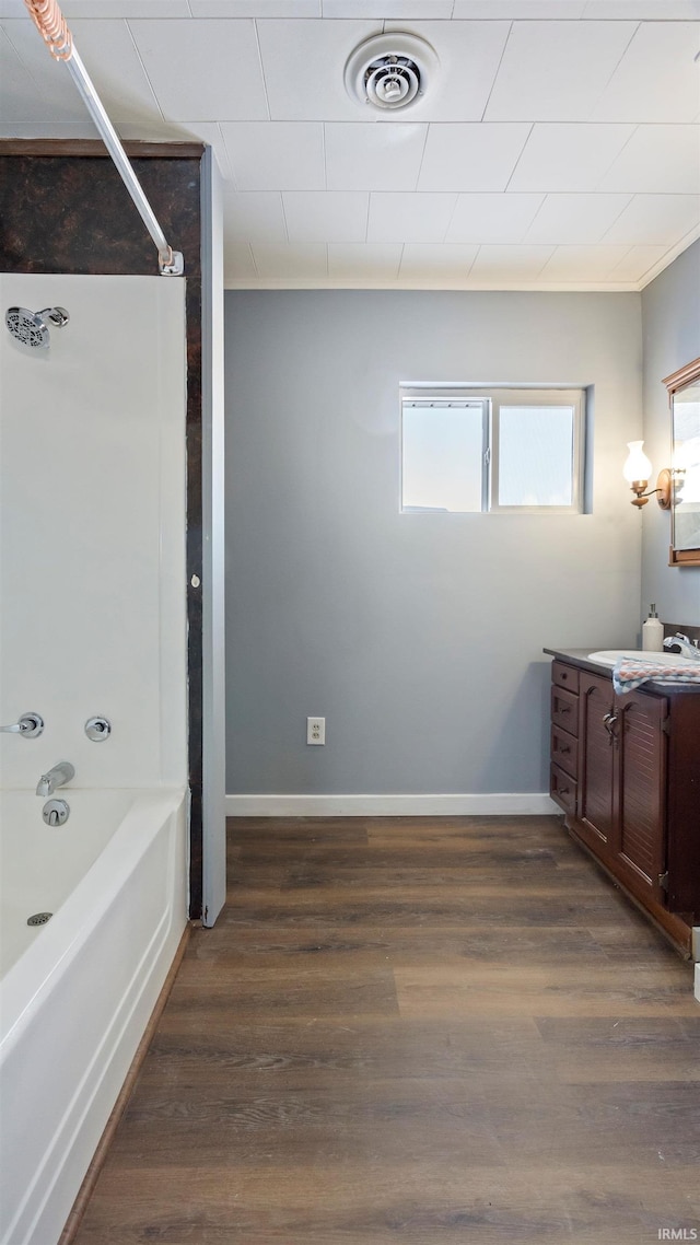 bathroom featuring tub / shower combination, crown molding, vanity, and wood-type flooring