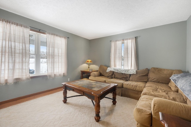 living room featuring a textured ceiling and light hardwood / wood-style floors