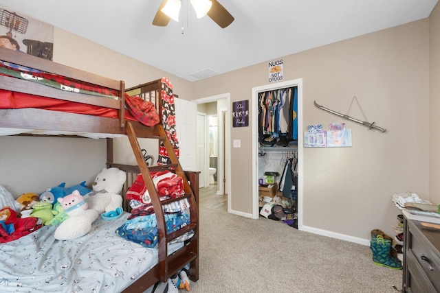 bedroom with ceiling fan, light colored carpet, and a closet