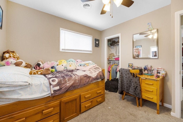 bedroom featuring ceiling fan, light colored carpet, a spacious closet, and a closet