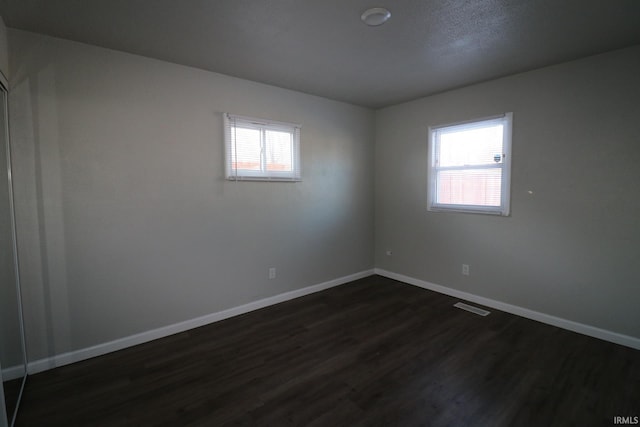 empty room featuring dark hardwood / wood-style floors