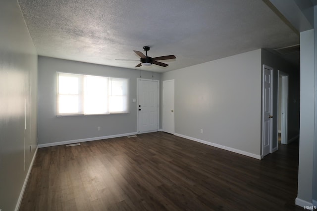 unfurnished room featuring a textured ceiling, ceiling fan, and dark hardwood / wood-style floors