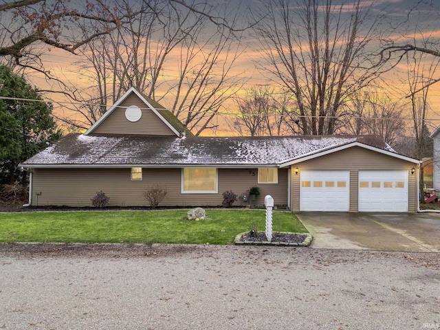 view of front of house featuring a garage and a lawn