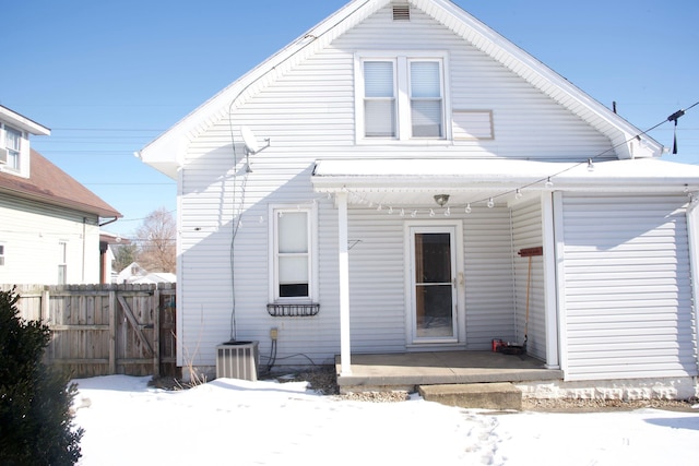 snow covered property featuring central AC