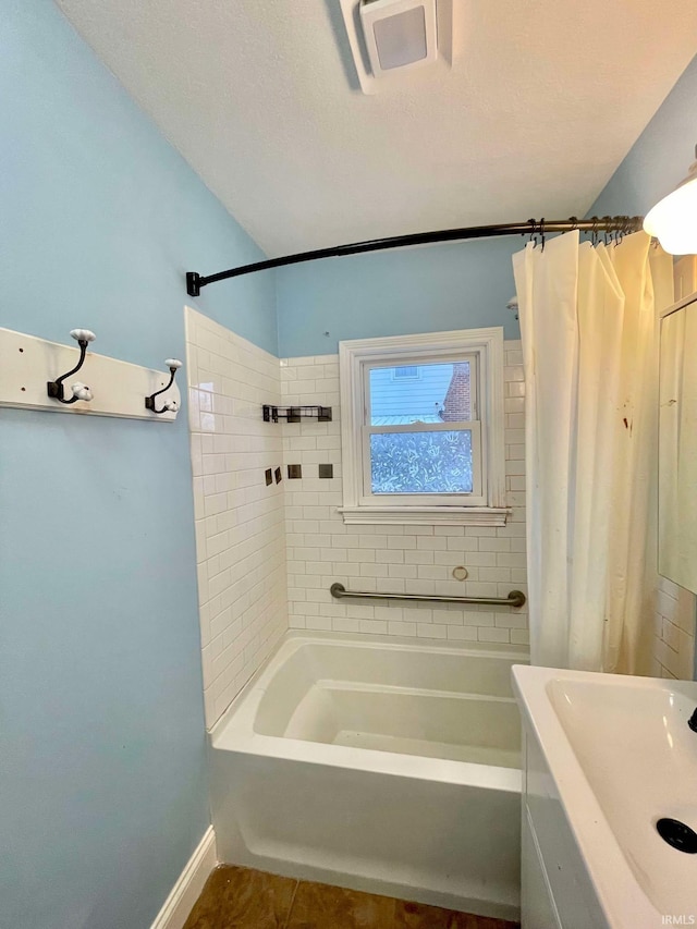 bathroom featuring sink, tile patterned floors, and shower / bathtub combination with curtain