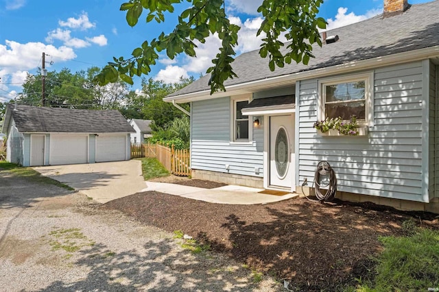 view of front facade with a garage and an outbuilding