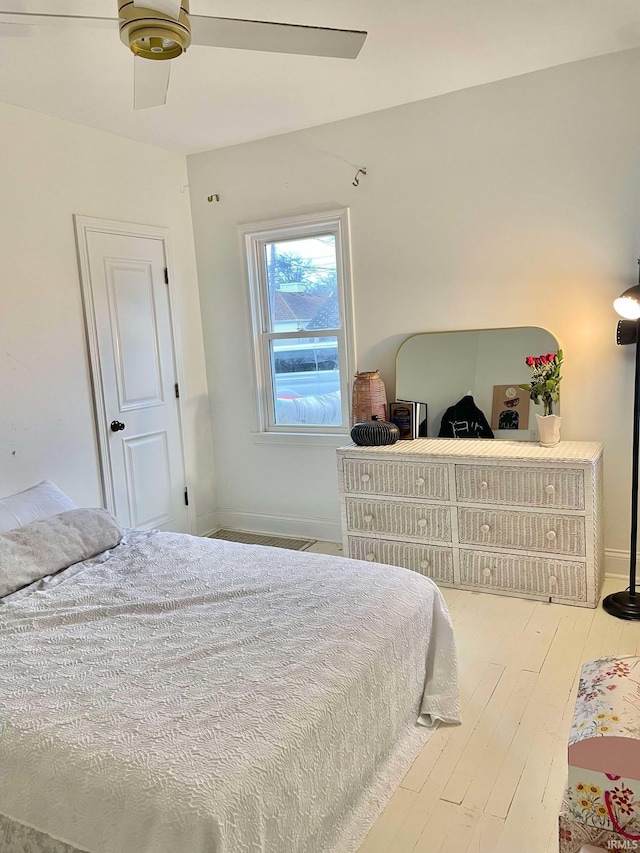 bedroom with ceiling fan and wood-type flooring