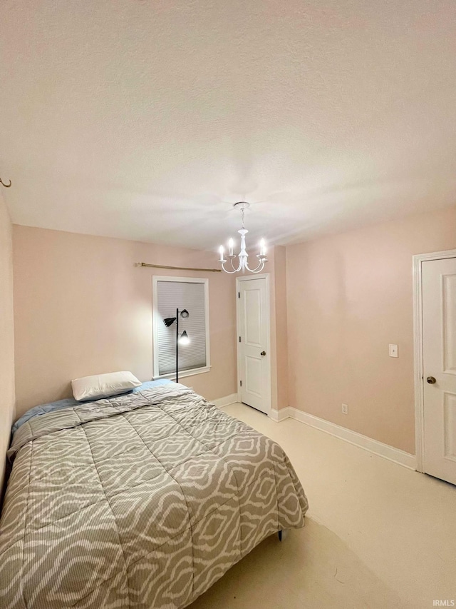 carpeted bedroom with a notable chandelier