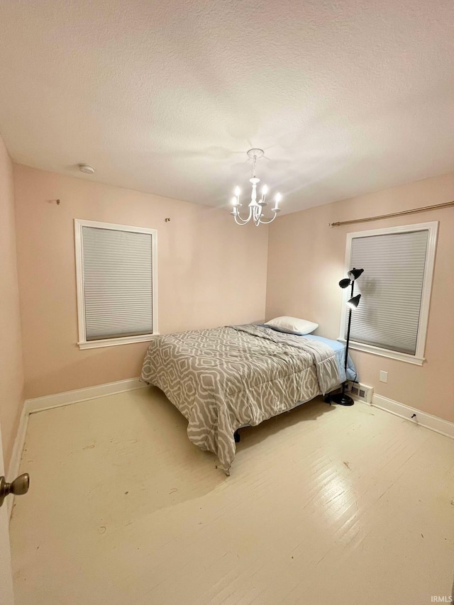 bedroom with a notable chandelier