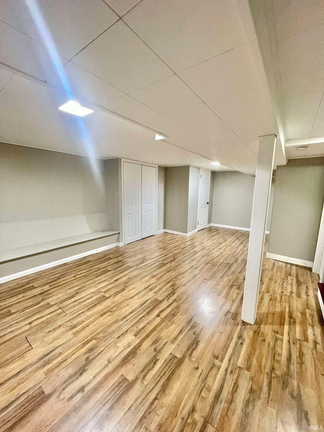 basement with light hardwood / wood-style flooring