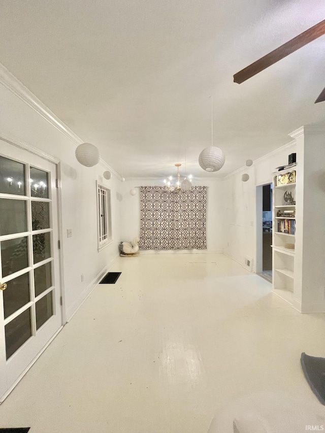 interior space featuring ornamental molding and a notable chandelier