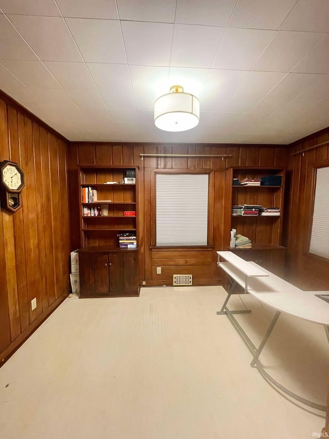 home theater room featuring wooden walls and built in shelves