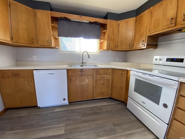 kitchen featuring white appliances, dark hardwood / wood-style floors, and sink