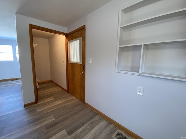 hallway featuring dark hardwood / wood-style flooring