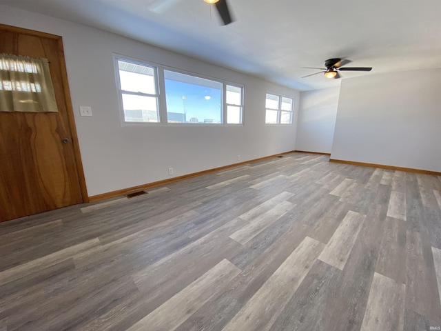 spare room with ceiling fan and wood-type flooring