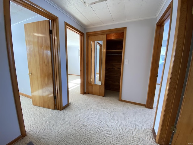 hall featuring crown molding and light colored carpet