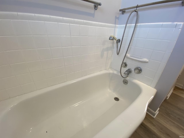 bathroom featuring hardwood / wood-style flooring and tiled shower / bath