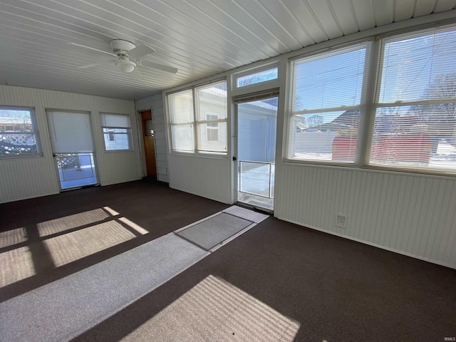 unfurnished sunroom featuring ceiling fan