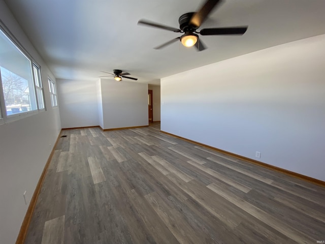 spare room featuring ceiling fan and dark wood-type flooring