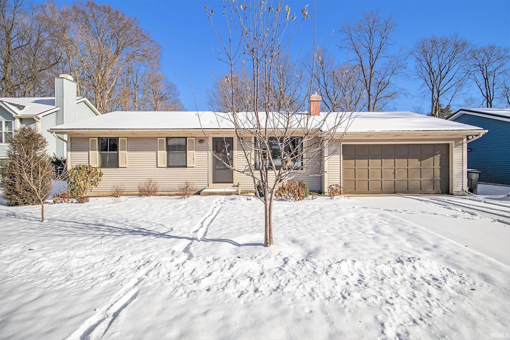 ranch-style home featuring a garage