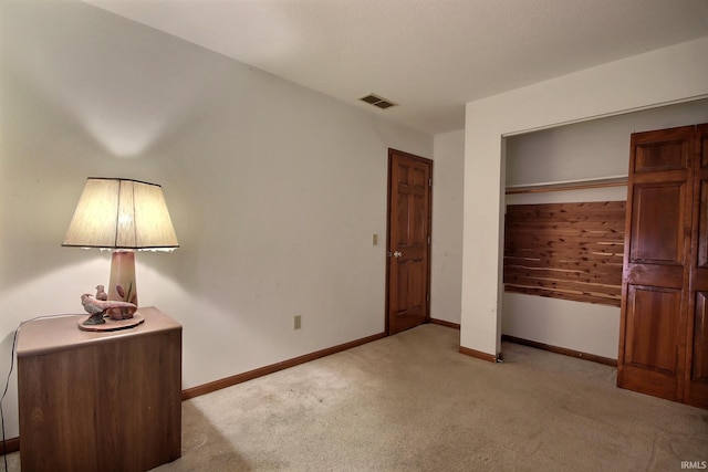 unfurnished bedroom featuring a closet and light carpet