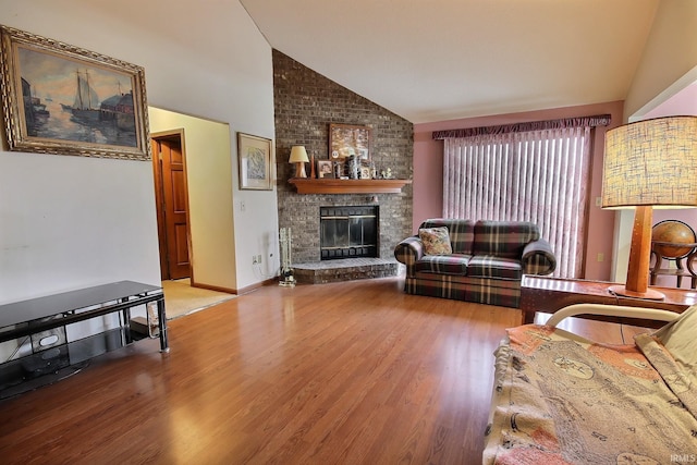 living room featuring a brick fireplace, lofted ceiling, and hardwood / wood-style flooring