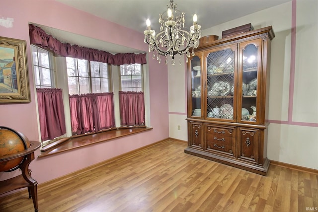 dining area with an inviting chandelier and light wood-type flooring