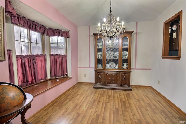 dining room featuring an inviting chandelier and light wood-type flooring