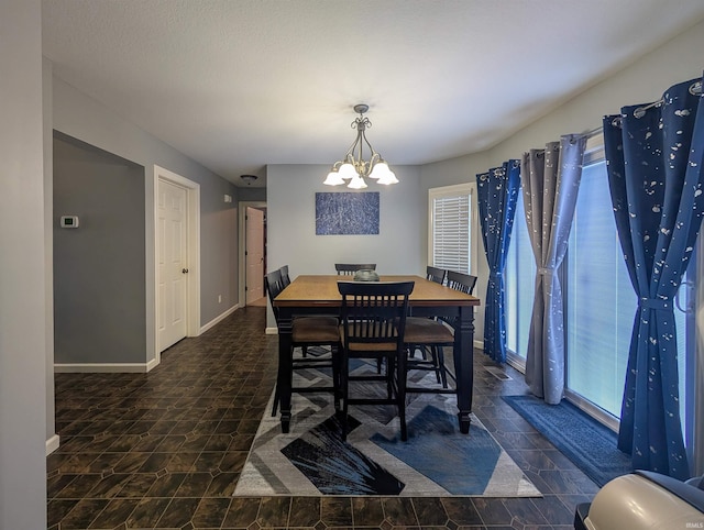 dining space with a notable chandelier