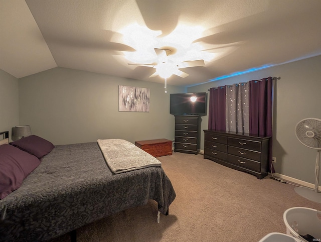 bedroom with lofted ceiling, ceiling fan, and carpet