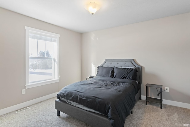 carpeted bedroom with multiple windows