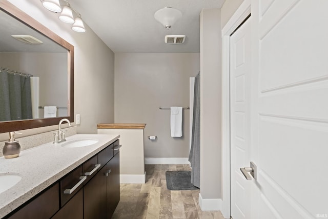 bathroom featuring vanity and hardwood / wood-style floors