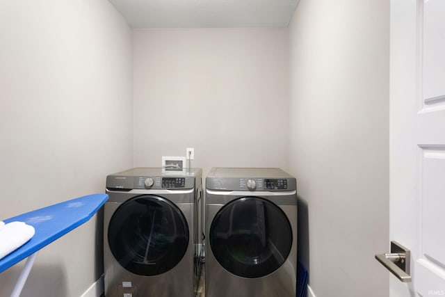 clothes washing area with washing machine and clothes dryer