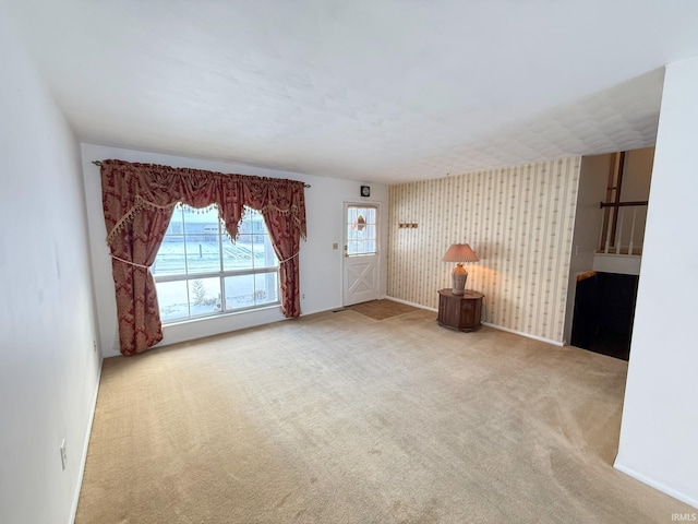 unfurnished living room featuring light colored carpet