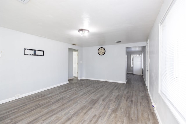 spare room featuring dark wood-type flooring