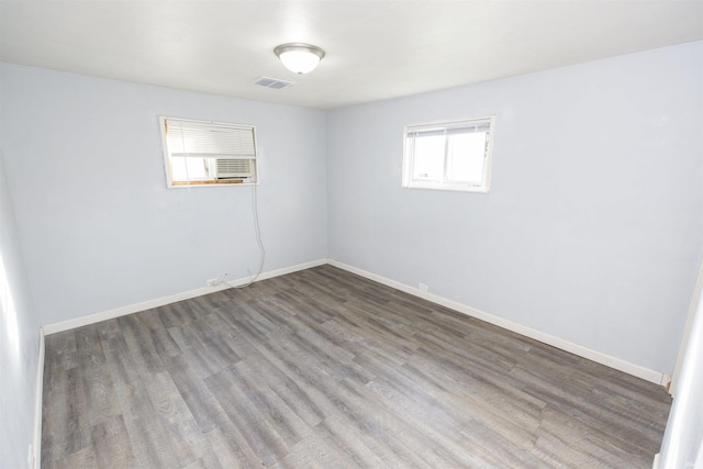 unfurnished room with wood-type flooring