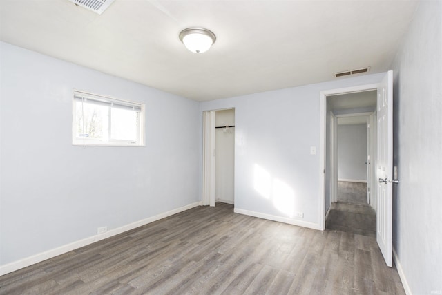 unfurnished bedroom with hardwood / wood-style flooring