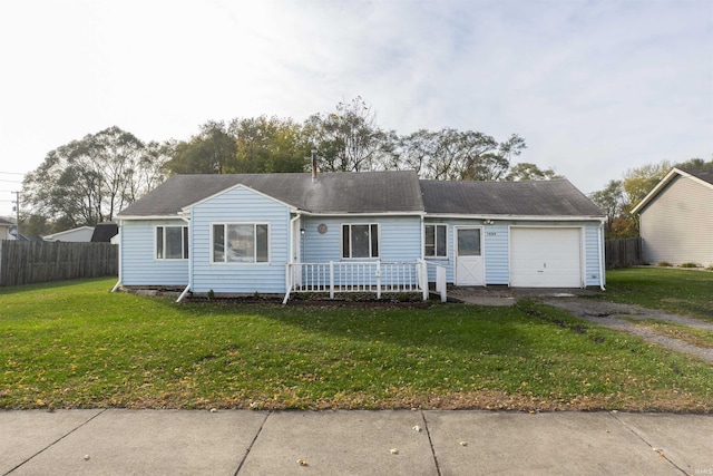 ranch-style house with a garage and a front lawn