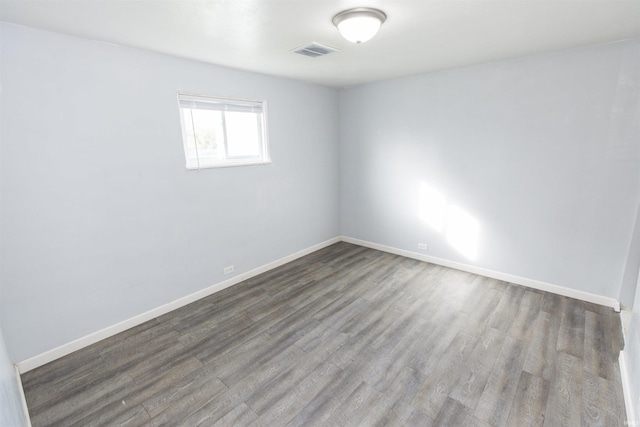 unfurnished room with wood-type flooring