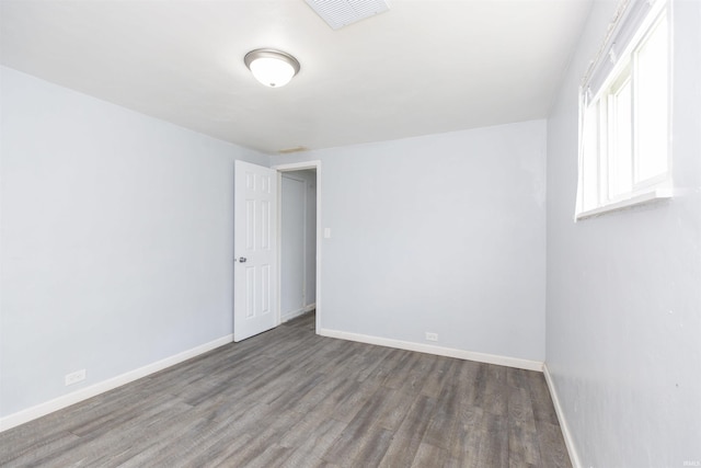 spare room with wood-type flooring