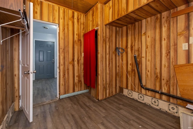 interior space featuring wooden walls and dark hardwood / wood-style floors