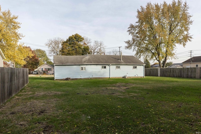 rear view of house with a lawn