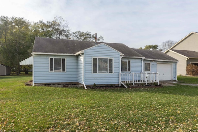 view of front of property with a front yard and a garage