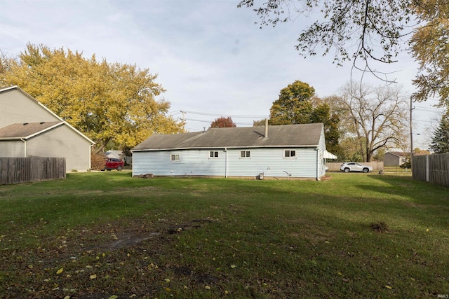 back of house with a yard