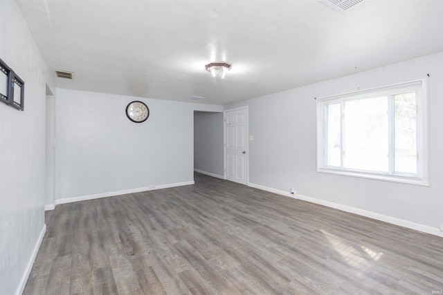 unfurnished room with dark hardwood / wood-style floors